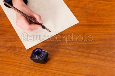 Woman writing a letter with pen and ink