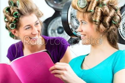 Women at the hairdresser with hair dryer