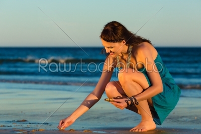 Women looking for shells at sunset
