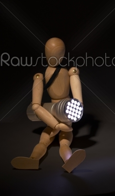 wood mannequin and flashlight
