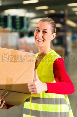 worker holds package in warehouse of forwarding
