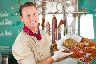Working in butchers shop with barbeque meat