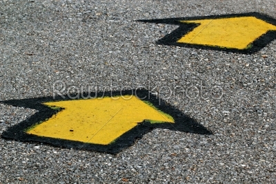 Yellow Arrows on Asphalt