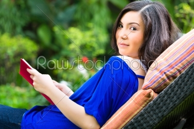 Young Asian woman at home in garden