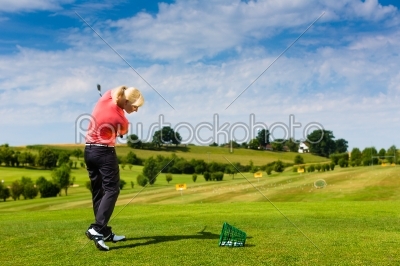 Young female golf player at Driving Range 