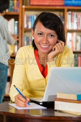 Young Girl in library with laptop