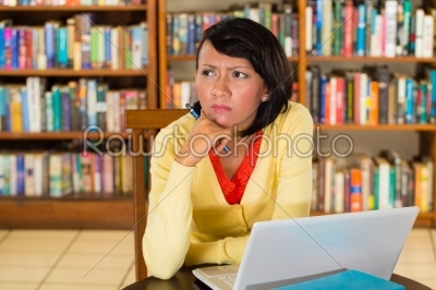 Young Girl in library with laptop