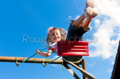 Young girl on the swing