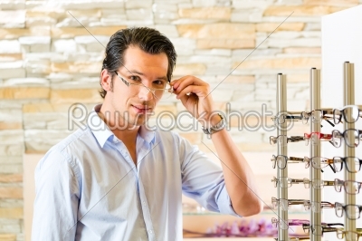 Young man at optician with glasses