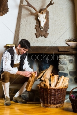 Young man in a hunter_qt_s cabin or alpine hut
