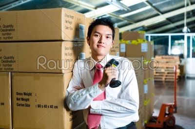 Young Man in a warehouse with Scanner