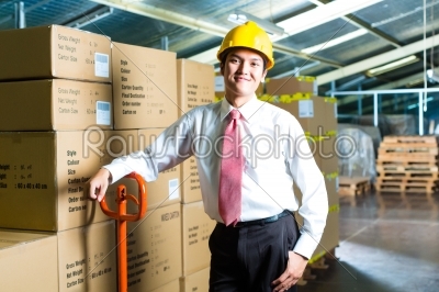 Young Man in warehouse he is a manager