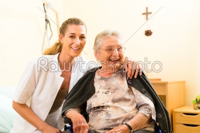 Young nurse and female senior in nursing home 