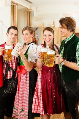 Young people in traditional Bavarian Tracht in restaurant or pub
