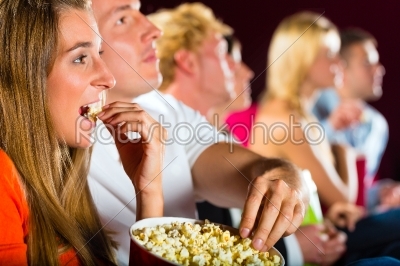 young people watching movie at movie theater