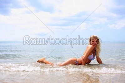 Young sexy woman posing on the beach