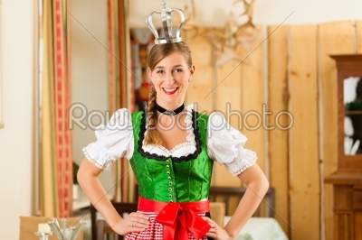 Young woman as queen in Traditional Bavarian Tracht in restaurant