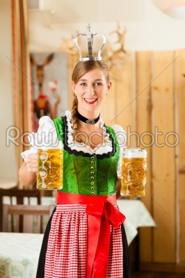Young woman as queen in Traditional Bavarian Tracht in restaurant