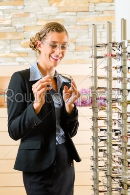 Young woman at optician with glasses