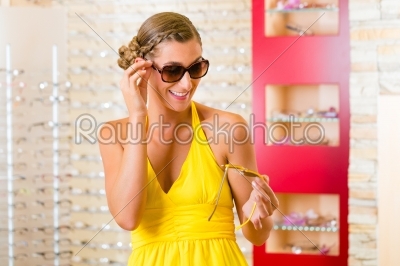 Young woman at optician with sunglasses