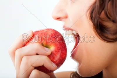 Young woman bites in a apple