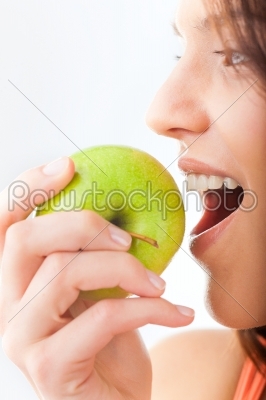 Young woman bites in a fresh and healthy apple