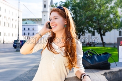 Young Woman calls with mobile phone in the Park