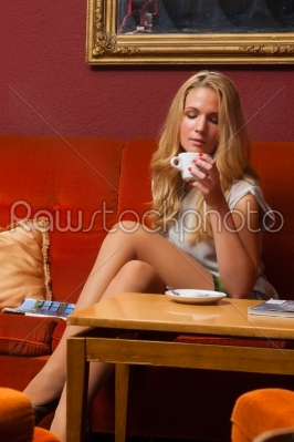 Young woman drinking a coffee or cappuccino 