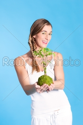 Young Woman holding a small tree