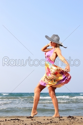 Young woman in dress and straw hat