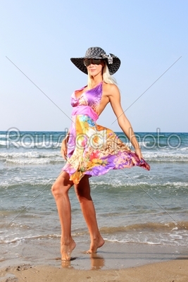 Young woman in dress and straw hat