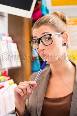 Young woman in Lotto shop playing ticket