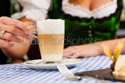 Young woman in traditional Bavarian Tracht in restaurant or pub