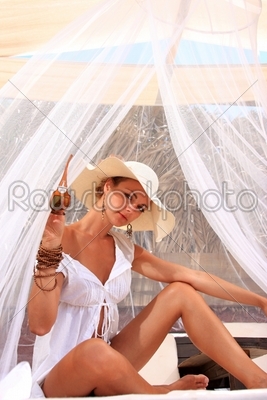 Young woman relaxing at lounge beach bar