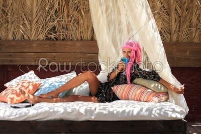 Young woman relaxing at lounge beach bar