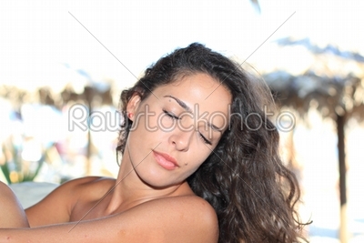 Young woman relaxing at summer lounge 