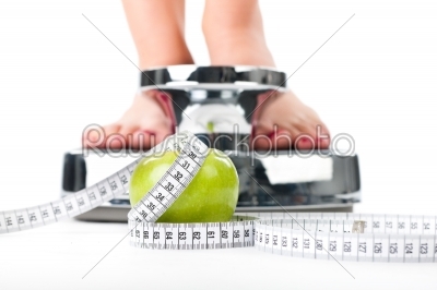 Young woman standing on a scale