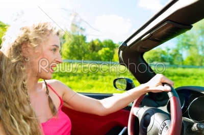 Young woman with cabriolet in summer on day trip