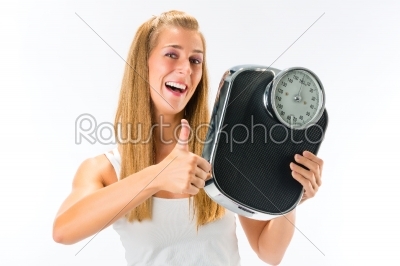 Young woman with weight scale 
