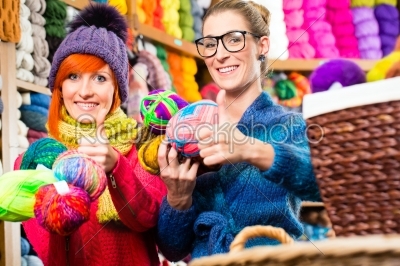 Young women in knitting fashion shop