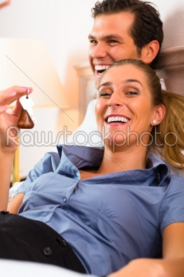stock photo: young couple lying on bed in hotel room-Raw Stock Photo ID: 46470