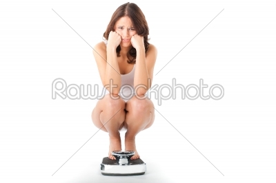 stock photo: young woman sitting on her haunches on a scale-Raw Stock Photo ID: 43855