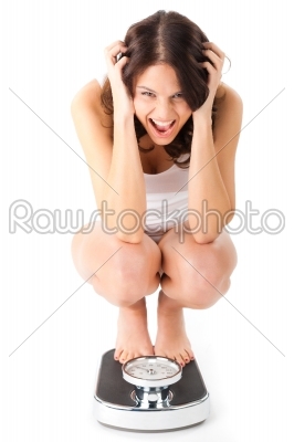 stock photo: young woman sitting on her haunches on a scale-Raw Stock Photo ID: 43856
