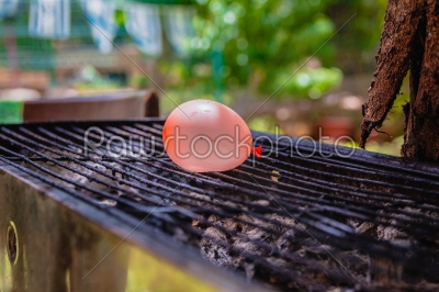 stock photo: balloon filled with water placed on a hot grill-Raw Stock Photo ID: 75163