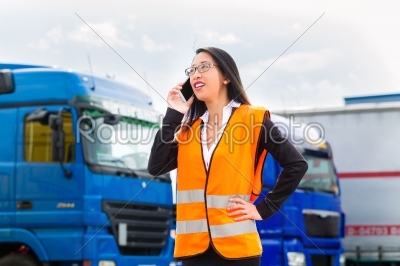 stock photo: female forwarder in front of trucks on a depot-Raw Stock Photo ID: 49260