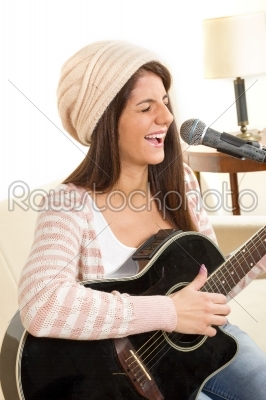 stock photo: girl with a guitar singing on microphone-Raw Stock Photo ID: 53289