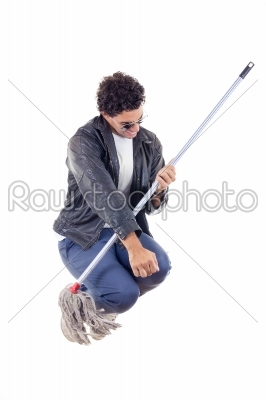  man in leather jacket jumps with a broom