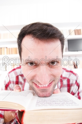 Adult businessman getting crazy with book in his hands