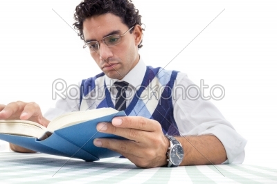 adult serious man in pullover with glasses sitting and reads boo
