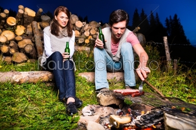 Alps - Couple at campfire in mountains